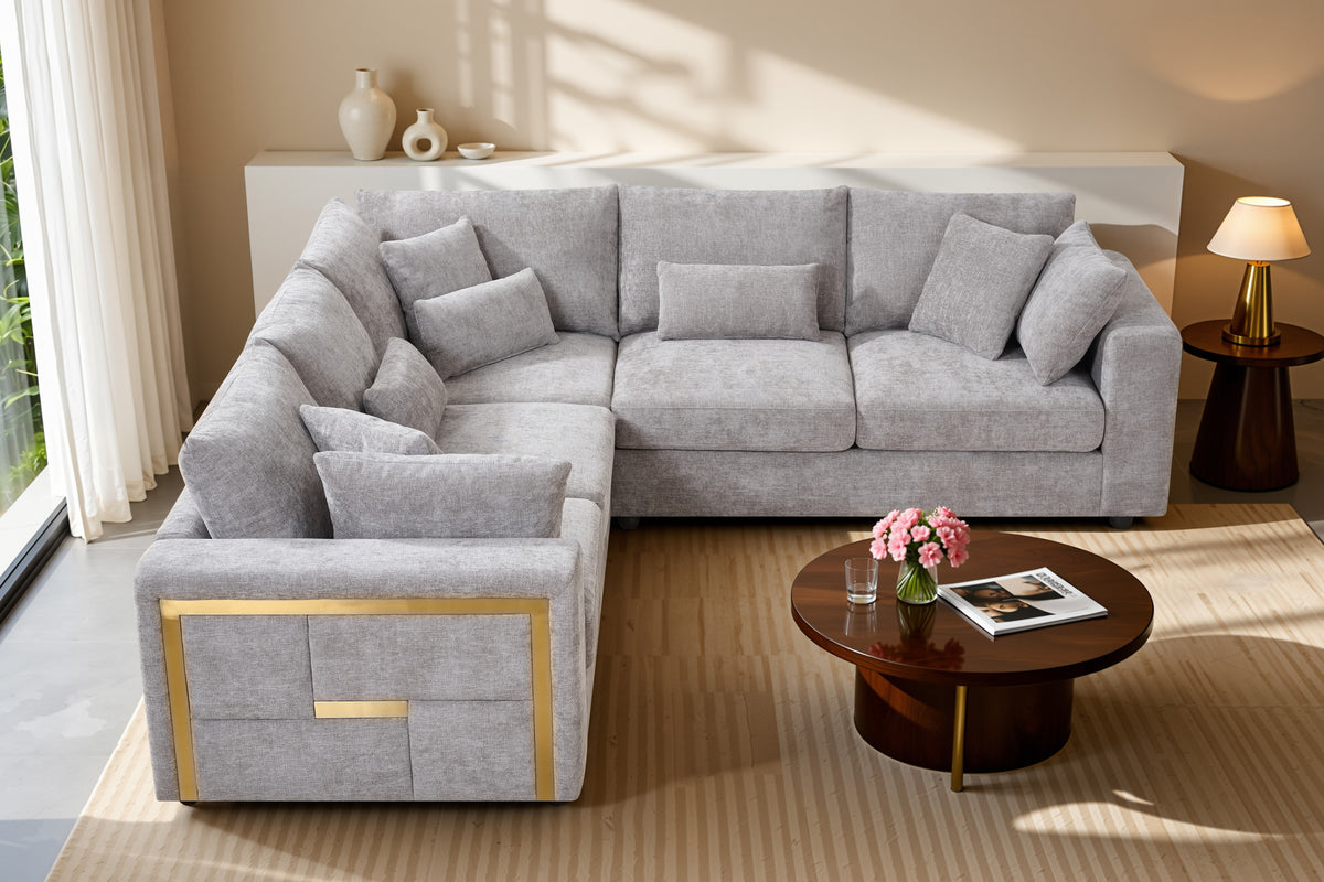 Gray sectional sofa in a living room with a coffee table and decorative items.