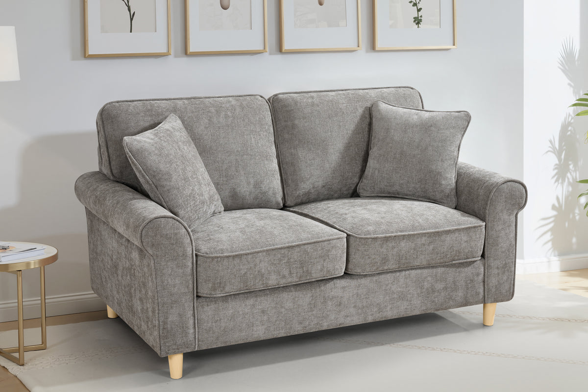 dark grey chenille fabric sofa with two accent cushions in a living room
