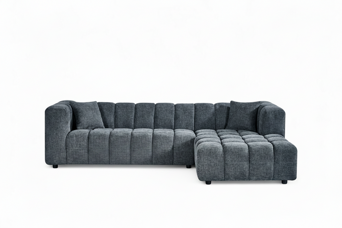 An L-shaped tufted sofa with right hand facing chaise end section, upholstered in pale blue chenille fabric