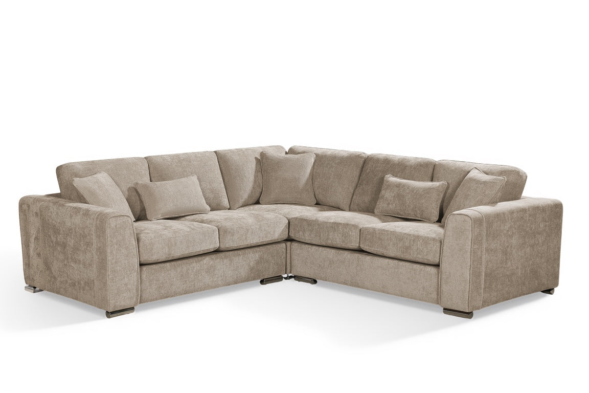 beige chenille upholstery corner sofa with fixed cushions and matching bolster cushions and scatter cushions, with silver modern-style legs and wide armrests