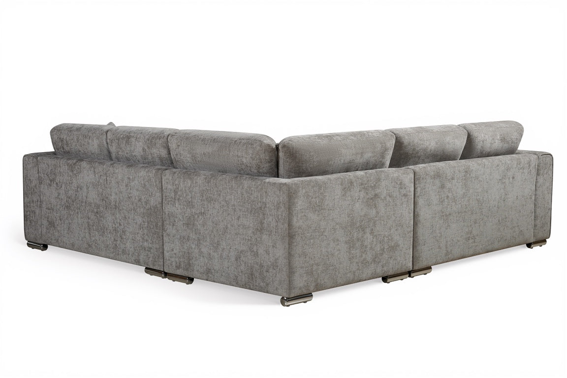 grey chenille upholstery corner sofa with fixed cushions and matching bolster cushions and scatter cushions, with silver modern-style legs and wide armrests