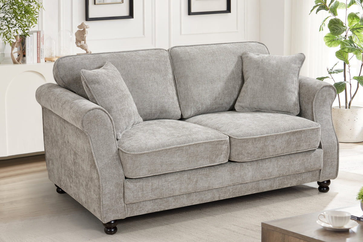 Grey chenille 2 seater sofa with accent cushions and wooden legs in a living room