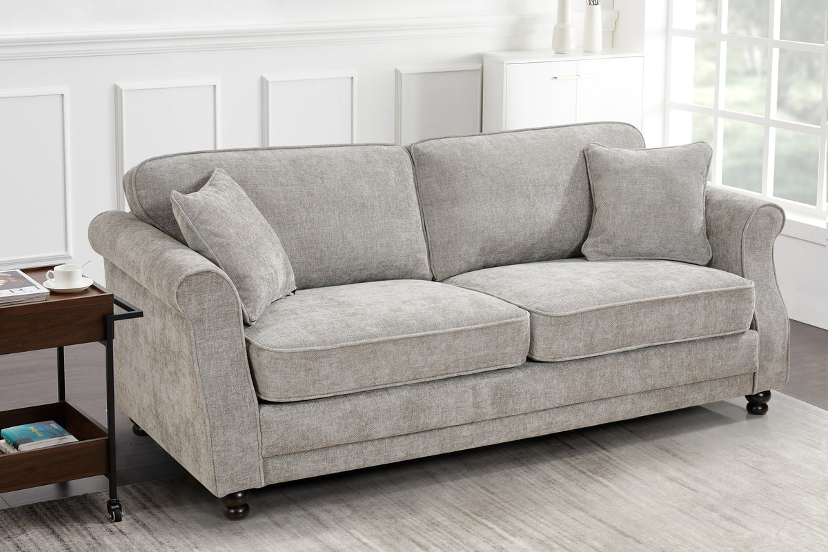 Grey sofa upholstered in chenille with two accent cushions in a living room