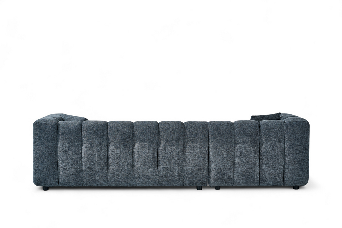An L-shaped tufted sofa with left hand facing chaise end section, upholstered in pale blue chenille fabric