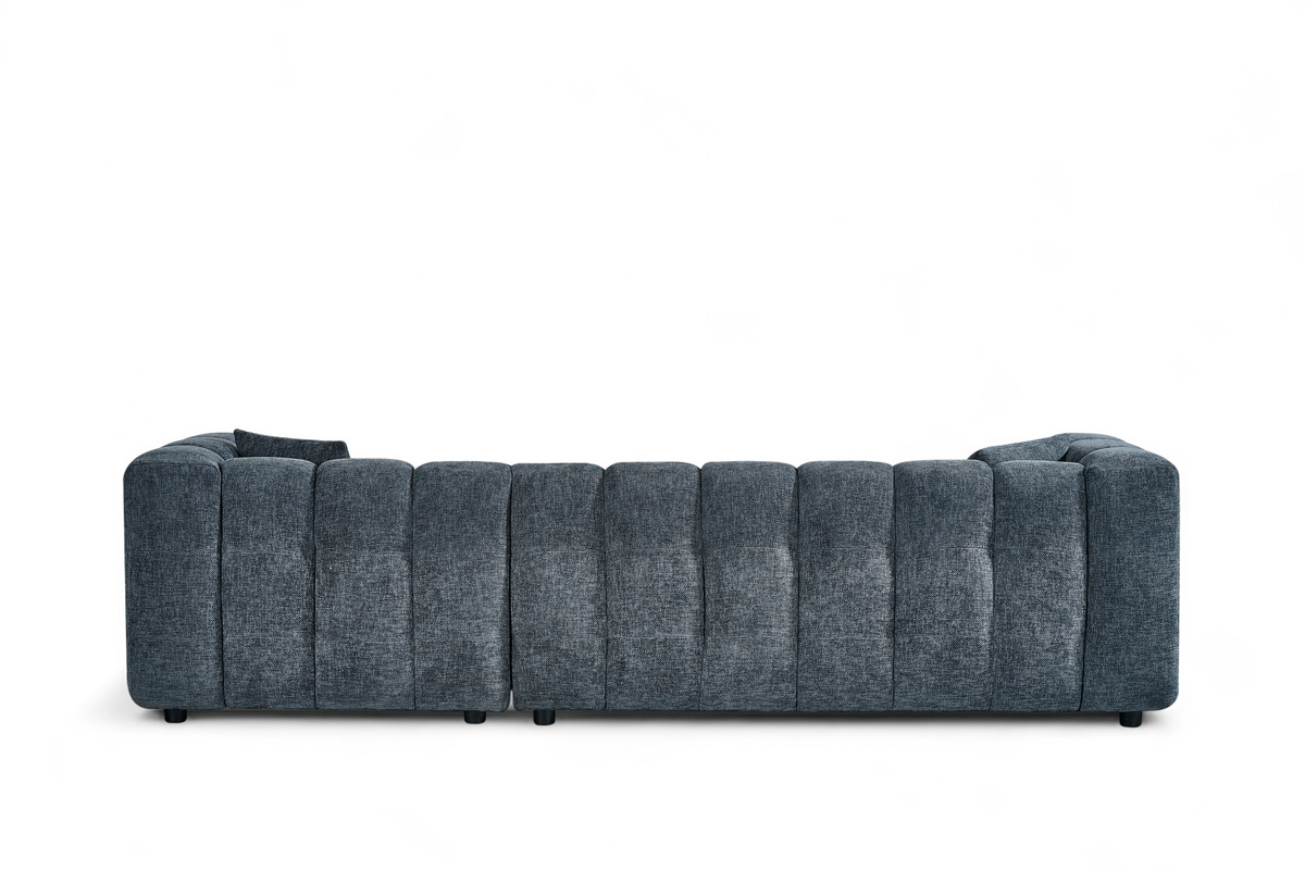 An L-shaped tufted sofa with right hand facing chaise end section, upholstered in pale blue chenille fabric