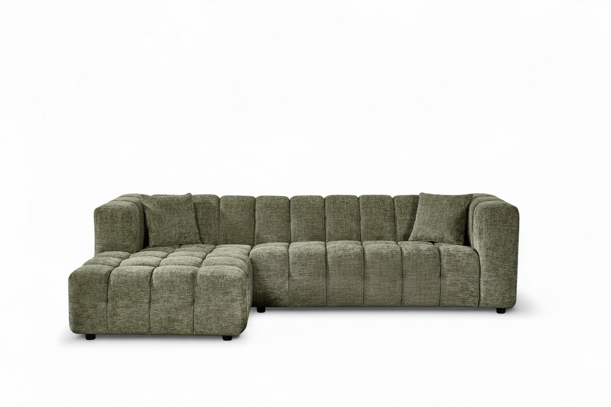 An L-shaped tufted sofa with left hand facing chaise end section, upholstered in textured sage green chenille fabric