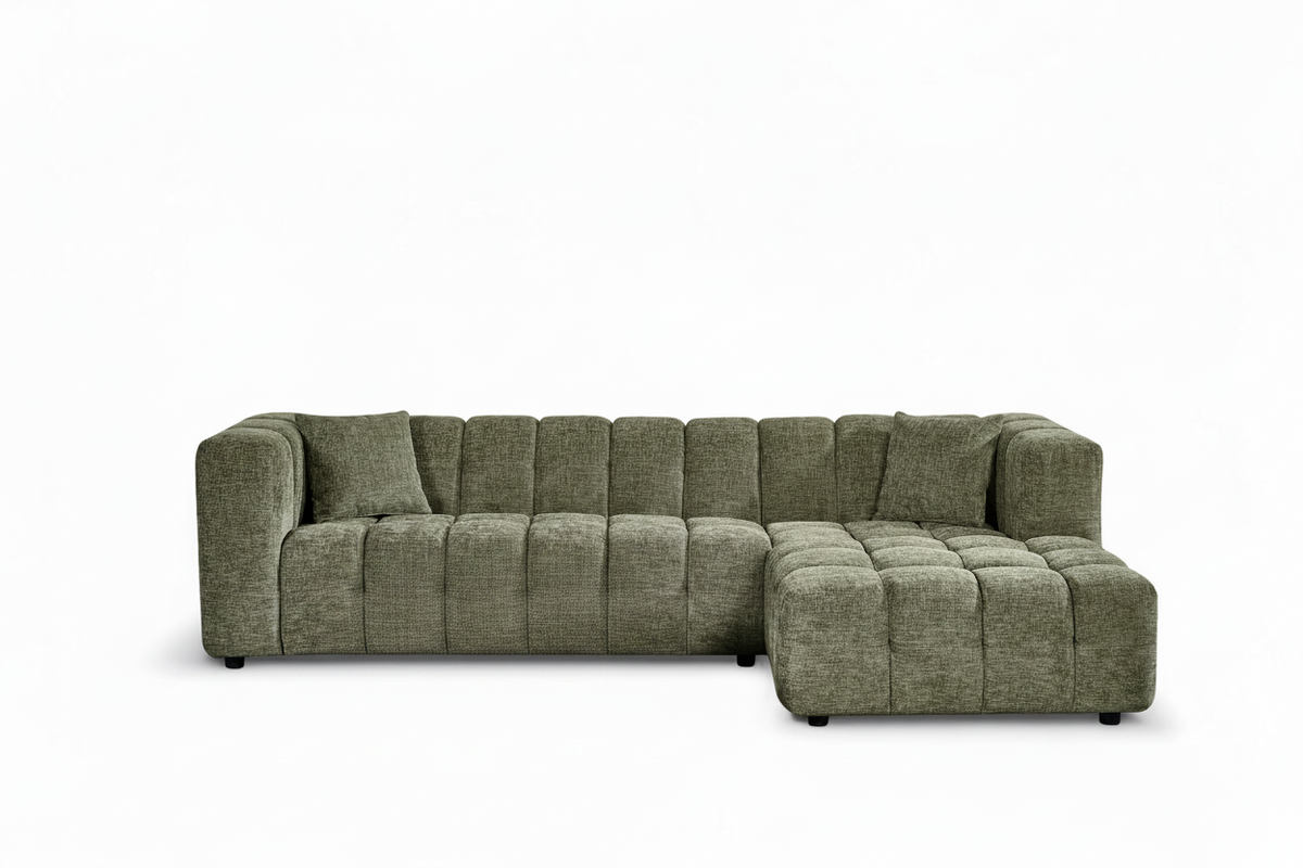 An L-shaped tufted sofa with right hand facing chaise end section, upholstered in textured sage green chenille fabric